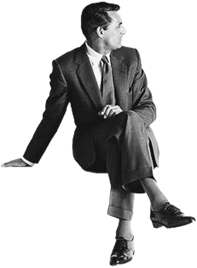 A man in a tailored suit, seated and looking off to one side.